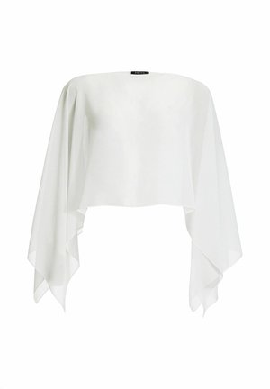 Haut blanc asymétrique ample avec manches longues et fluides et un large décolleté bateau, étiqueté "SWING" au col.