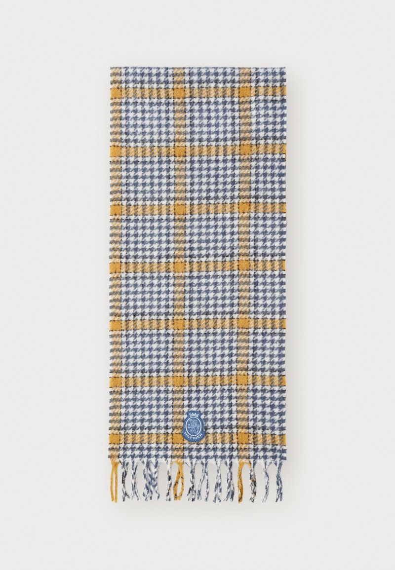 Woven scarf in blue and white houndstooth pattern, featuring yellow check accents. Finished with fringed edges and a blue logo patch.