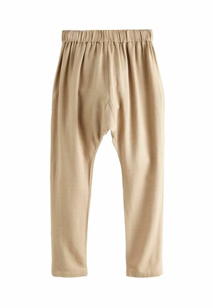Pantaloni di cotone beige con cintura elastica, caratterizzati da una vestibilità rilassata e gambe affusolate. Il tessuto ha una texture liscia e leggera.