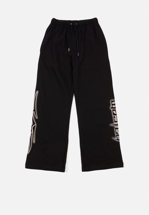 Black sweatpants with an elastic waistband and drawstring. Features graphic accents in a lighter shade on the sides. Soft fabric texture.