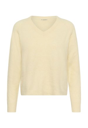 Džemperis ar V formas kakla izgriezumu no mīksta, gaiši dzeltena auduma. Raksturots ar garām piedurknēm un brīvu piegriezumu ar ribotiem aprocēm un apakšmalu.