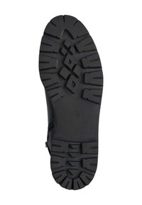 Semelle en caoutchouc noire avec des motifs de bande de roulement profonds, présentant diverses formes géométriques. Taille 37 marquée au fond. Design durable pour une adhérence optimale.