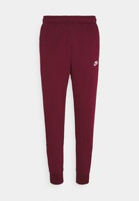 Vinröda Nike sweatpants med elastisk midja, smalnande ben, ribbade ankle och liten vit Nike-logotyp på vänster lår.