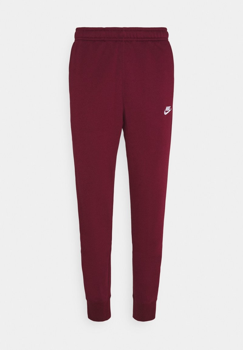 Vinröda Nike sweatpants med elastisk midja, smalnande ben, ribbade ankle och liten vit Nike-logotyp på vänster lår.
