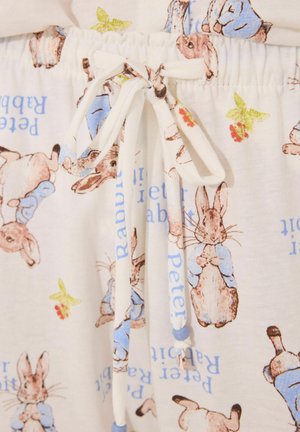 White fabric pajama shorts featuring a repeated print of Peter Rabbit, with blue accents and a drawstring waist.