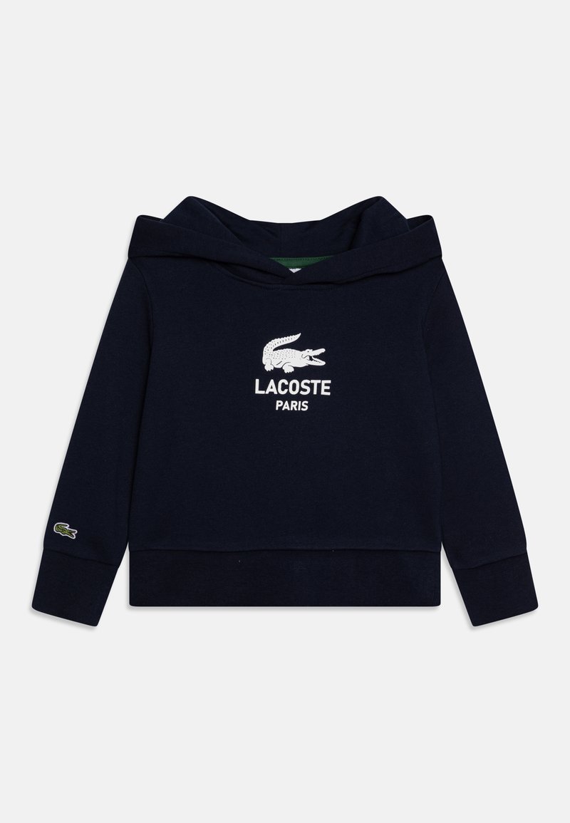 Felpa navy blue in cotone, con cappuccio regolabile, logo coccodrillo ricamato in bianco e testo "LACOSTE PARIS" sul davanti.