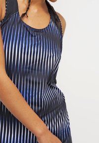 Zwart en blauw mouwloos sporttop met verticale gestreepte patronen en een gestructureerde halslijn. Lichtgewicht, aansluitend ontwerp.