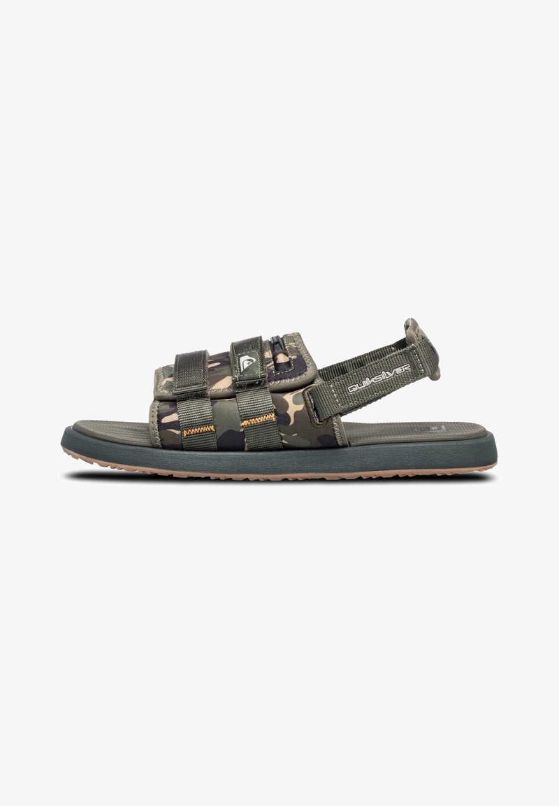 Camouflage-patterned sandal with adjustable straps, rubber sole, and cushioned footbed. Features a side logo and stitching accents.