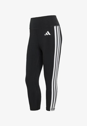 Crne sportske helanke s visokim pojasom, s tri bijele okomite pruge duž vanjske strane i malim logotipom sprijeda.