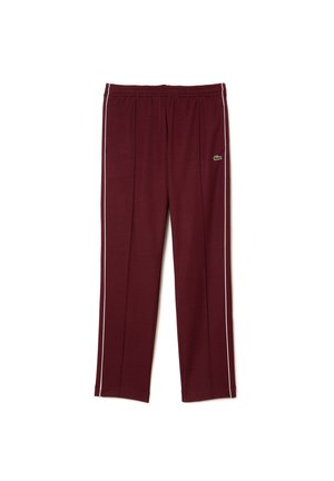 Pantalon de sport bordeaux avec liseré blanc sur les côtés, taille élastique et petit logo vert sur la cuisse supérieure.