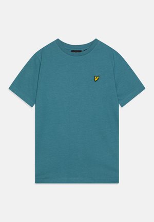 Plava pamučna majica s okruglim izrezom, kratkim rukavima i žutom izvezenom pticom na lijevoj strani grudnog koša. Smooth tekstura, ležerni kroj.