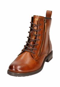 Braune Leder-Ankle-Boots mit Schnürung und seitlichem Reißverschluss. Verfügt über einen flachen Absatz und dezente Markenkennzeichnung an der Oberseite. Glatte, polierte Oberfläche.
