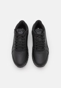 Czarne buty sportowe wykonane z syntetycznej skóry, z wyściółką na kołnierzu, sznurowanym zapięciem, teksturowanymi podeszwami oraz akcentami z logo na języku i boku.