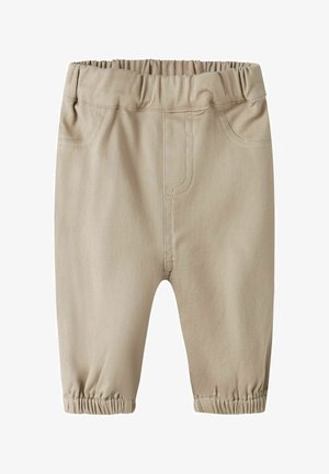 Beiget vauvanhousut, joissa on joustava vyötärö ja nilkkakaitaleet, etutaskut ja näkyvät ompelusaumat.