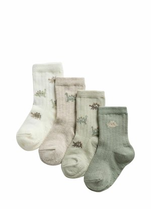 Vier Paar Kindersocken in Weiß, Beige, Hellgrün und Grün mit kleinen Tiermustern und rutschfesten Punkten an den Sohlen.
