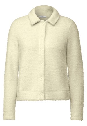 Cardigan en crème clair fait d'un tissu doux et texturé. Il possède un col pointu, une fermeture à boutons sur le devant et des manches longues.