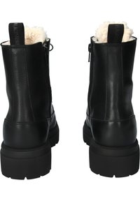 Zwarte leren enkellaarzen met een zachte witte voering, ritssluitingen aan de zijkant en gestructureerde zwarte rubberen zolen. Voorzien van een trekkoord aan de achterkant.