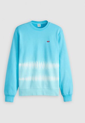 Svetlomodrá mikina so vzorom tie-dye s prechodovým efektom. Žebrované manžety a výstrih, malá červená nášivka na hrudi.