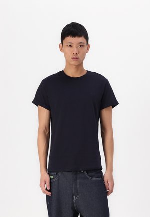 Navyblauwe katoenen t-shirt met een ronde hals en korte mouwen. Heeft een subtiele logo op de borst en een ontspannen pasvorm.