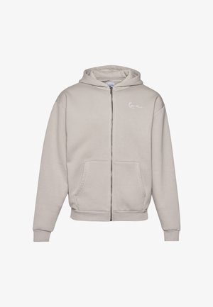 Beežist lukuga kapuutsiga pusa, millel on paelaga kapuuts, ees taskud ja soonikkoes mansetid. Rinnal tikitud logo. Pehme kangapind.