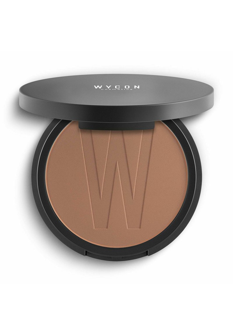 Bronzer compatto con una texture liscia e opaca. Caratterizzato da una tonalità abbronzata e il logo "W" in rilievo. Scatola circolare nera con coperchio piatto.