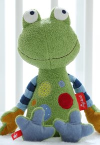 Green plush frog toy with a textured body, striped sleeves, and colorful polka dots. Features orange, blue, and yellow accents on the hands.