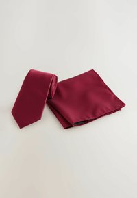 Burgundy tie and pocket square set. Both feature a textured pattern. The tie is rolled, while the pocket square is flat with clean edges.