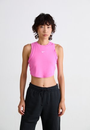 Pink crop top with a round neckline and white logo, paired with black sweatpants featuring an elastic waistband and adjustable drawstring.