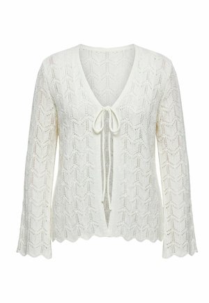 Hvid strikket cardigan med chevronmønster, lange klokkeærmer, bølget kant og åben front bundet med en sløjfe ved brystet.