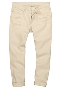 Beige Denimhosen mit schmaler Passform, fünf Taschen, Reißverschluss und umgeschlagenen Säumen. Verfügt über dezente Seitennaht und Metallnieten.