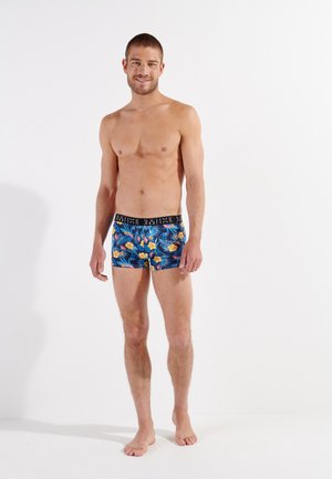 Herren-Boxershorts in einem bunten Blumenmuster mit Blau, Gelb und Grün. Schwarzer elastischer Bund mit Logo. Glattes, elastisches Gewebe.