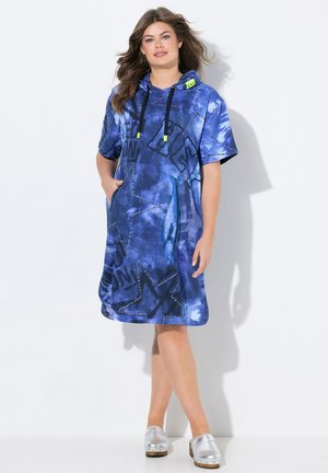 Vestido tipo sudadera de mezclilla azul con mangas cortas, bolsillo frontal y detalles de hardware amarillos. Presenta texto estampado y diseños de estrellas.