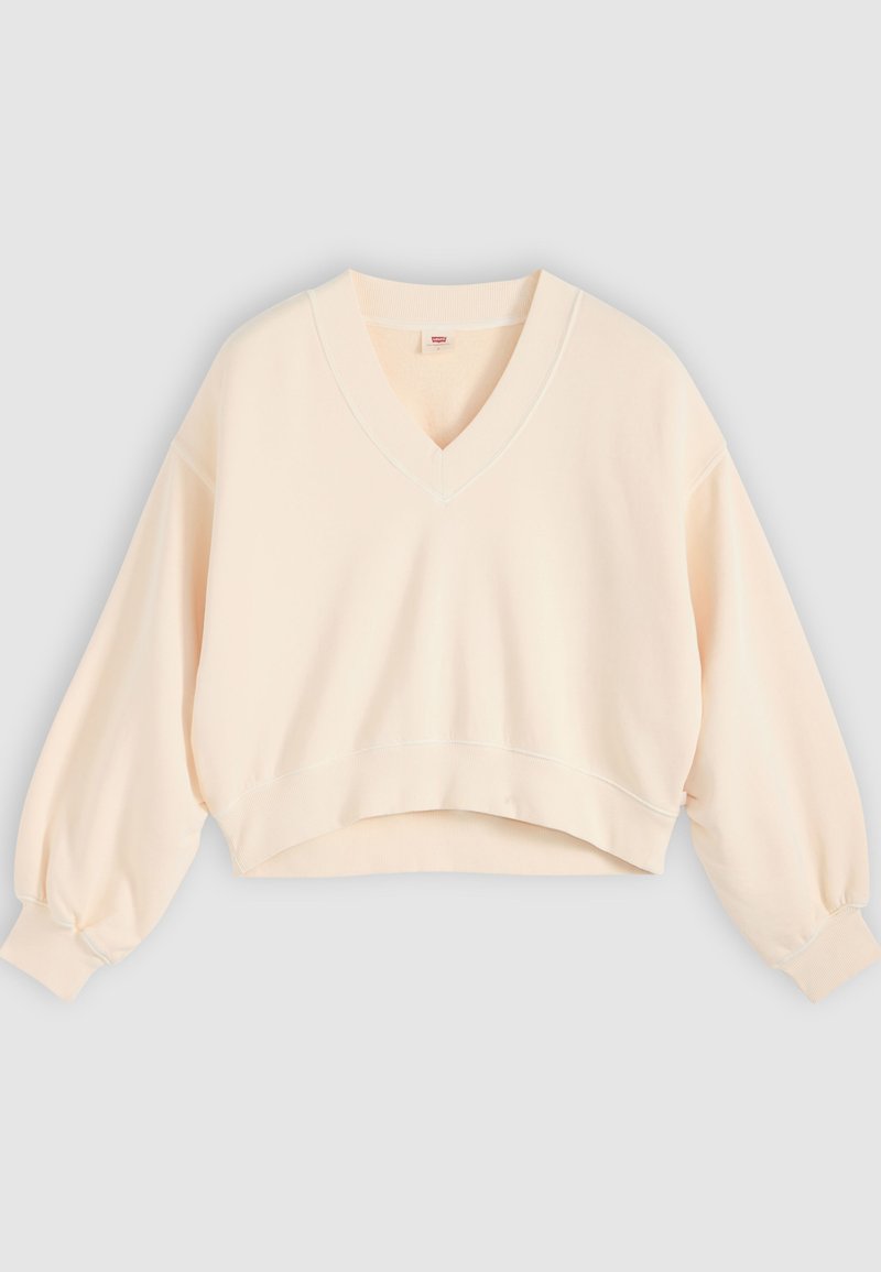 Pull crop couleur crème à manches longues avec col en V et poignets et ourlet côtelés, présenté sur un fond gris clair uni.