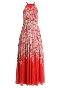 Robe maxi longue rouge à fleurs avec un col noué autour du cou, une jupe plissée et des motifs floraux complexes de différentes couleurs sur un tissu transparent.