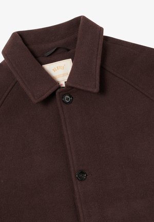 Brown wool coat with a structured collar, featuring a single button closure and a soft, textured fabric. Label visible inside.
