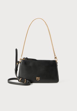 Black leather handbag with gold chain strap, zip closure, and a small logo detail on the front. Features an additional shoulder strap.