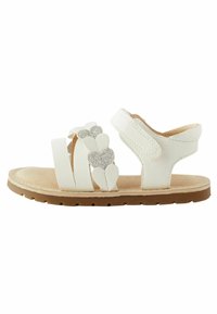 Weiße Sandalen mit herzförmigen, glitzernden Akzenten, verstellbarem Riemen und rutschfester, brauner Gummisohle; weiche Innenpolsterung für Komfort.