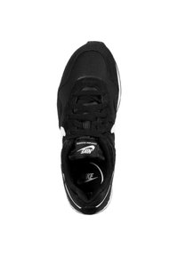 Black sneaker made of mesh and suede, featuring laces, a rounded toe, white accents, and a black logo on the tongue and side.