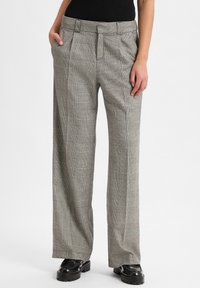 Karierte weite Hosen in Grau und Schwarz, mit hoher Taille, Falten und seitlichen Taschen, aus einem strukturierten gewebten Stoff gefertigt.