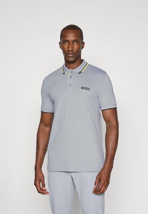 Grey polo shirt with black and neon yellow collar accents, featuring three buttons and "BOSS" logo on the left chest. Smooth cotton fabric.