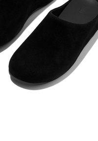 Zwarte instapschoenen gemaakt van zacht suède. Ronde neus, minimalistisch ontwerp en een platte zool met een gladde textuur.