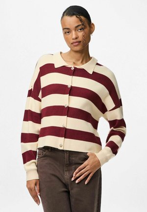 Svītrains kardigans krēmkrāsā un burgundijas tonī ar apkakli, priekšējām pogām un vaļēju piegriezumu. Adīts ar garām piedurknēm un ribotu apdari piedurkņu galiem.