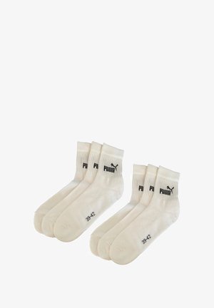 Six pairs of white Puma ankle socks with black Puma logo and size 39-42 printed near toes, arranged in two rows on a white background.