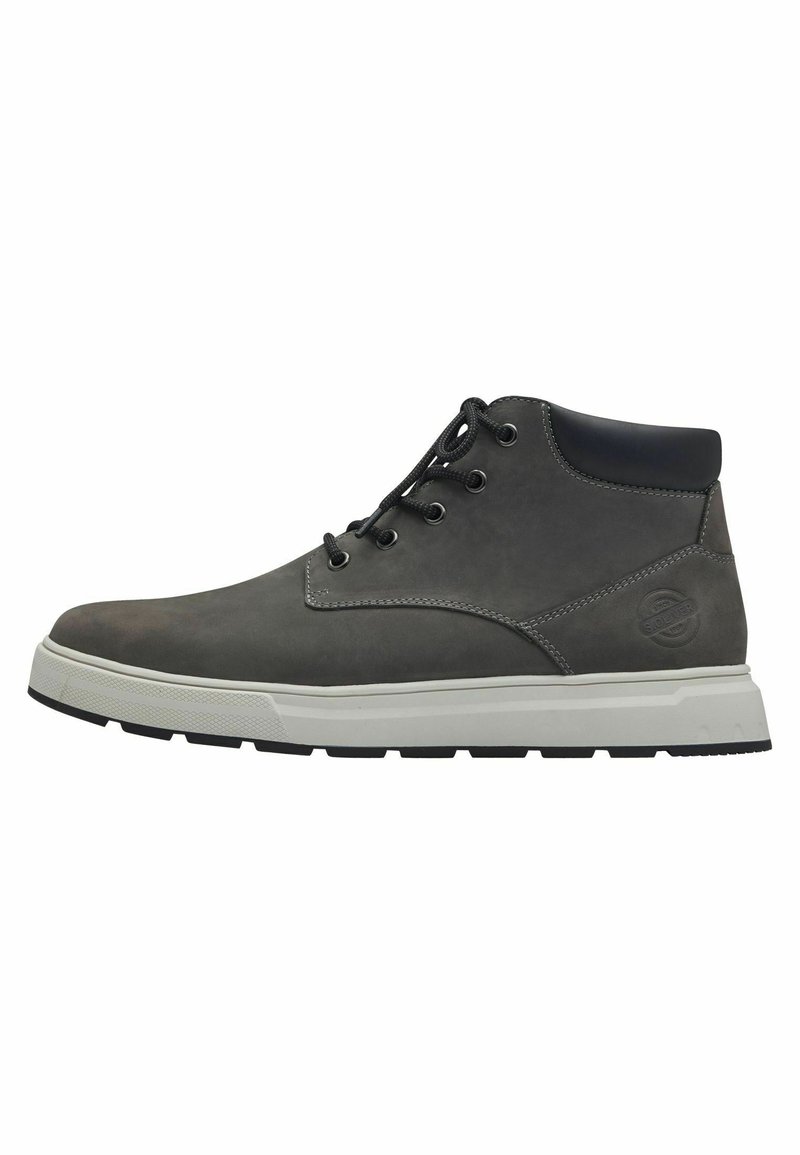 Gray leather ankle boots with black accents, featuring round laces, a white sole, and textured surface detailing. Side logo prominently displayed.
