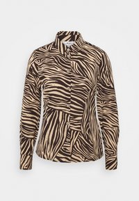 Langærmet skjorte med knapper i beige og brun med et zebra-stribemønster. Har en krave og matchende knapper foran.