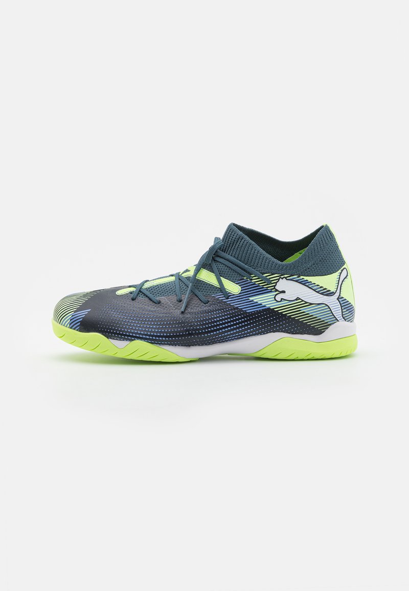 Navy and lime green athletic shoes with textured upper, round toe, and a snug, sock-like collar. Features contrasting stripes and Puma logo.
