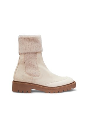 Beige Knöchelschuhe mit einem weichen cremefarbenen Obermaterial, einem strukturierten, flauschigen Bündchen, einer Gummisohle mit Profil und einem dezent geprägten Logo an der Seite.