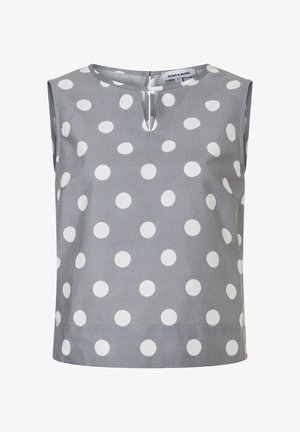 Blouse grise sans manches avec de grands pois blancs et un petit détail d'encolure en forme de trou de serrure à l'avant.