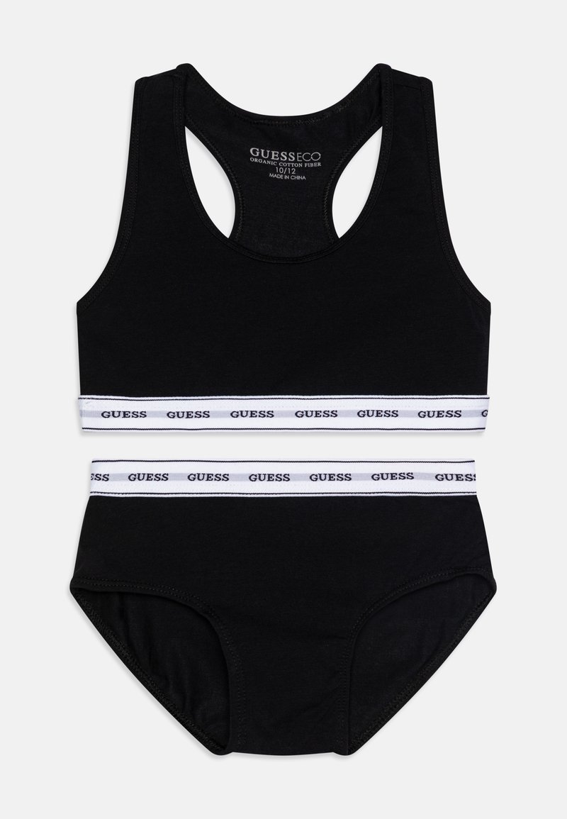 Maillot de bain noir deux pièces en coton bio, comprenant un haut de style racerback orné d'une bande de logo blanche et un bas assorti avec un détail de bande similaire.