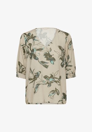 Blouse florale avec un décolleté en V, manches courtes élastiques, tissu beige avec des motifs floraux verts et teal, texture légère et semi-transparente.